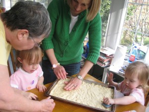 Working with Grandma and Mommy on the press cookies Working with Grandma and Mommy on the press cookies