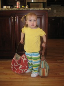 Hadley with her Mommy's and Aunt Marian's purses (as you know, 2 purses is trendy with the toddler set) Hadley with her Mommy's and Aunt Marian's purses (as you know, 2 purses is trendy with the toddler set)