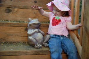 Hadley giving her frog a pat