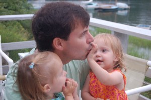 Lydia trying a clam and Hadley shoving one into Allan's mouth