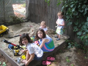Zoe, Eva, Hadley, and Lydia in the sandbox