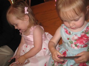 Lydia and Hadley lasted the whole ceremony thanks to the magic of mom and dad's phones