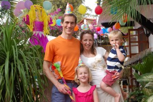 Truman, Nisa, Alden, and birtday girl Maren, with birthday decorations and pinata